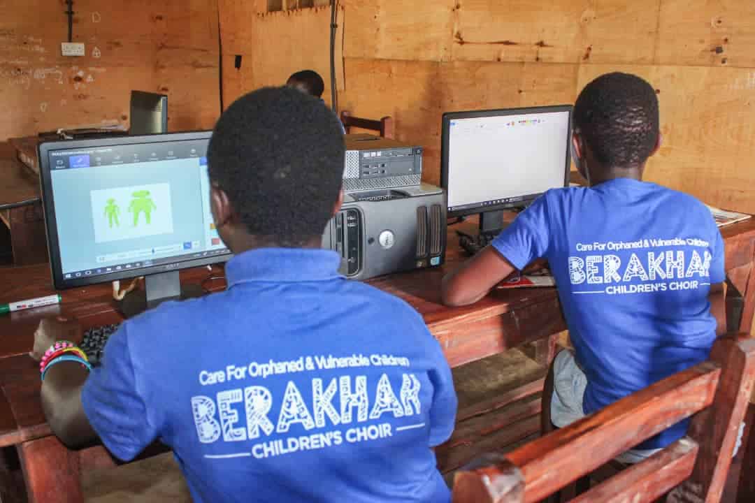 Choir members learning computer skills